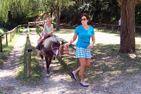 petting zoo mom leading pony