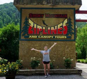 Smoky-Mountain-Zipline-Jess-in-front-of-sign Smoky-Mountain-Zipline-in-front-of-sign