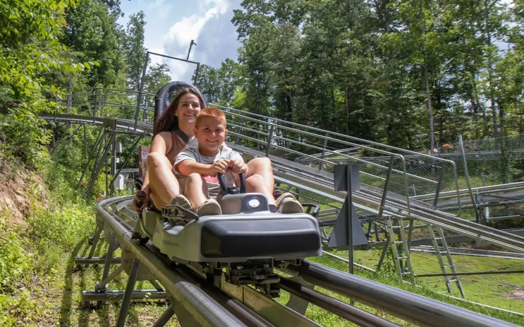 Boy and Girl Riding Coaster at Rocky Top Mountain Coaster