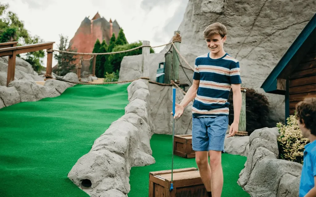 Brothers Playing Putt Putt at Lost Treasure Golf
