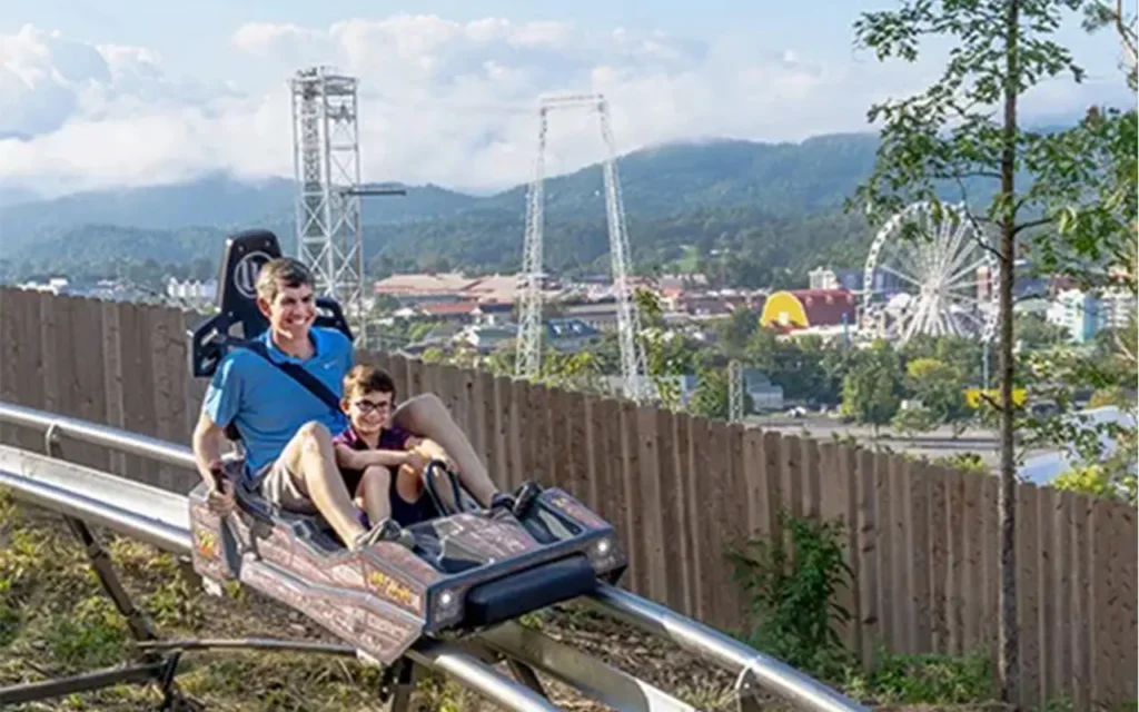 Dad and Son Riding Coaster at Lost Mine Mountain Coaster and Mini-Golf