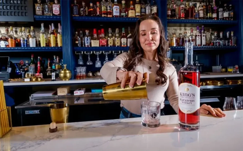 Girl Pouring a Drink at Kings Family Distillery