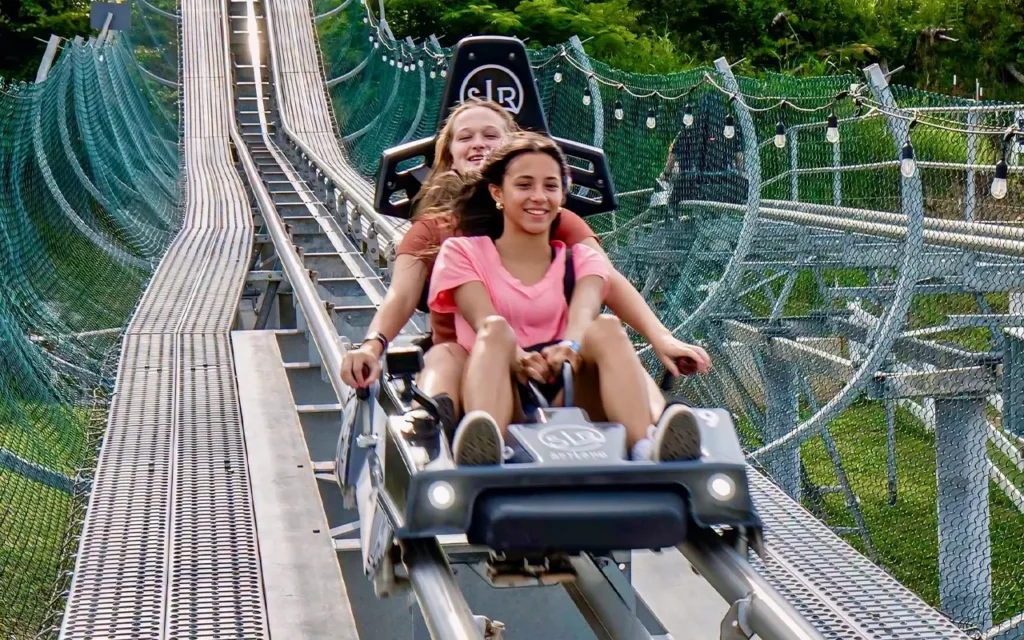 Girls Riding The Wild Stallion Mountain Coaster at Skyland Ranch