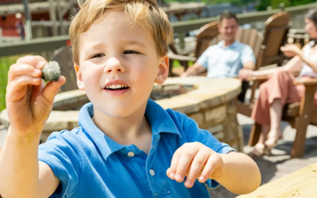 Kid Finding Treasure at Lost Mine Mountain Coaster and Mini-Golf
