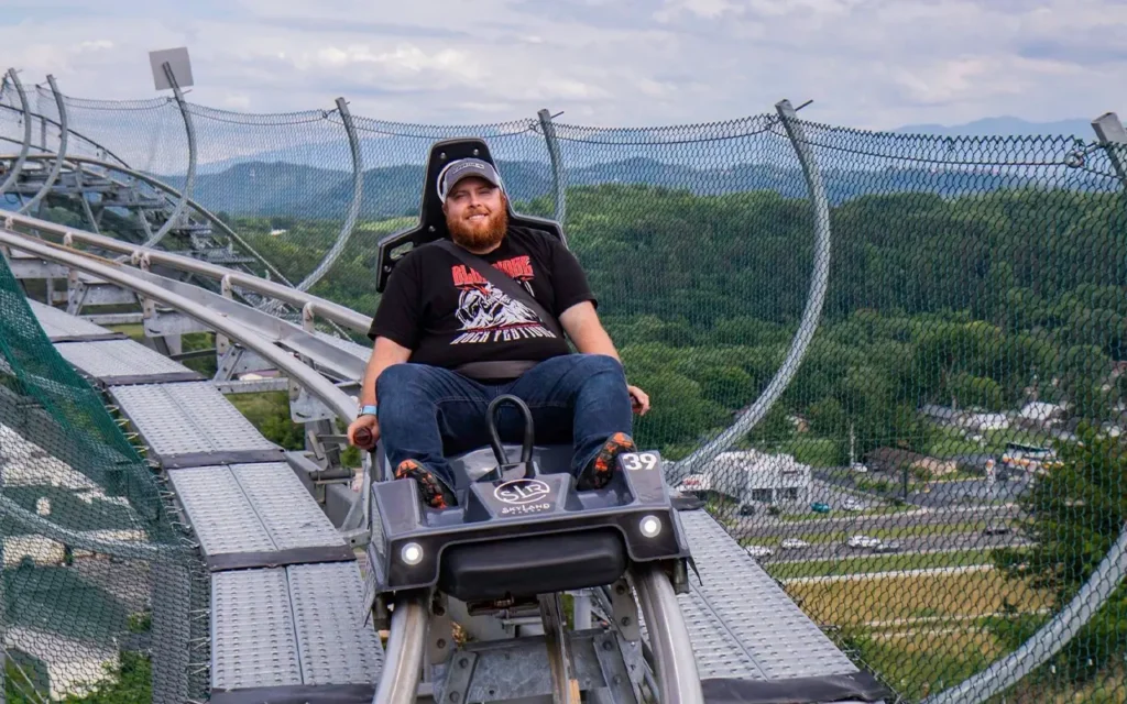 Man Riding The Wild Stallion Mountain Coaster at Skyland Ranch