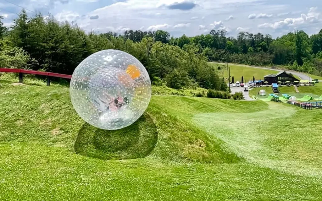 Person Riding Down Hill at Outdoor Gravity Park